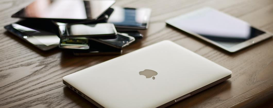 Technology on a table protected against Cyber Crimes and Phishing Scams